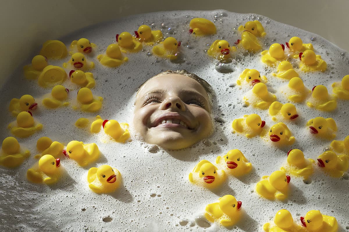 Linda taking joyful bath with yellow ducks